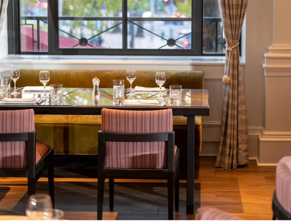 Settle in for intimate dinners beside glowing city windows.