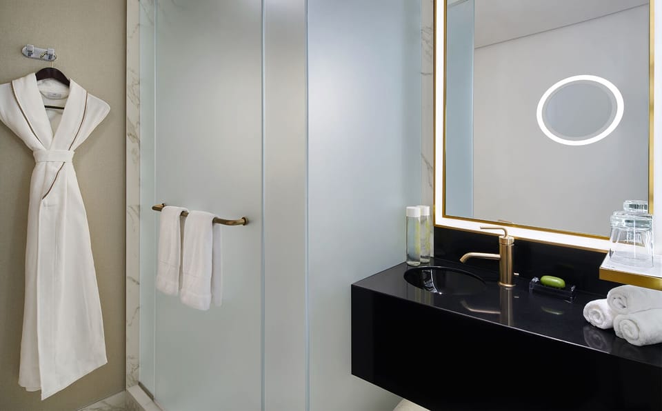 Get ready effortlessly with a glowing mirror and sleek vanity.