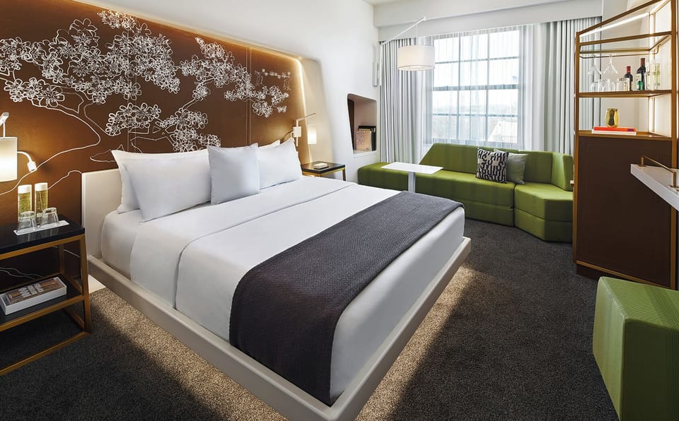 Unwind on crisp linens beside a cozy lounge nook.