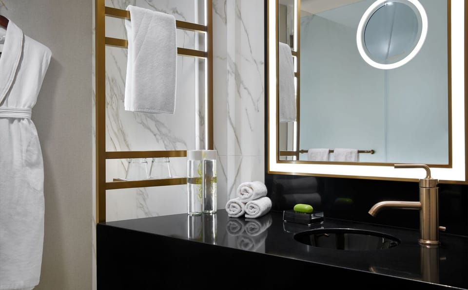 Freshen up at a sleek vanity with spa-like lighting.