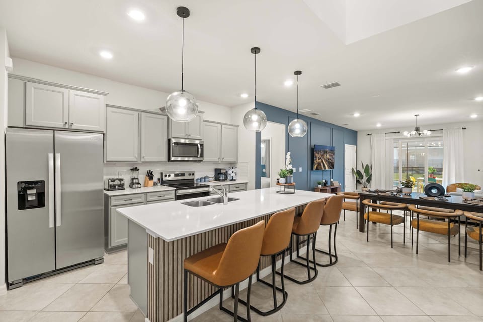 Elegant kitchen and dining area with modern amenities, perfect for hosting and entertaining in style.