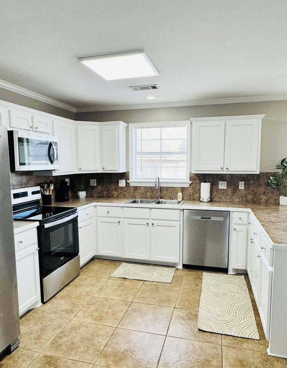 Fully equipped kitchen with stainless steel appliances.