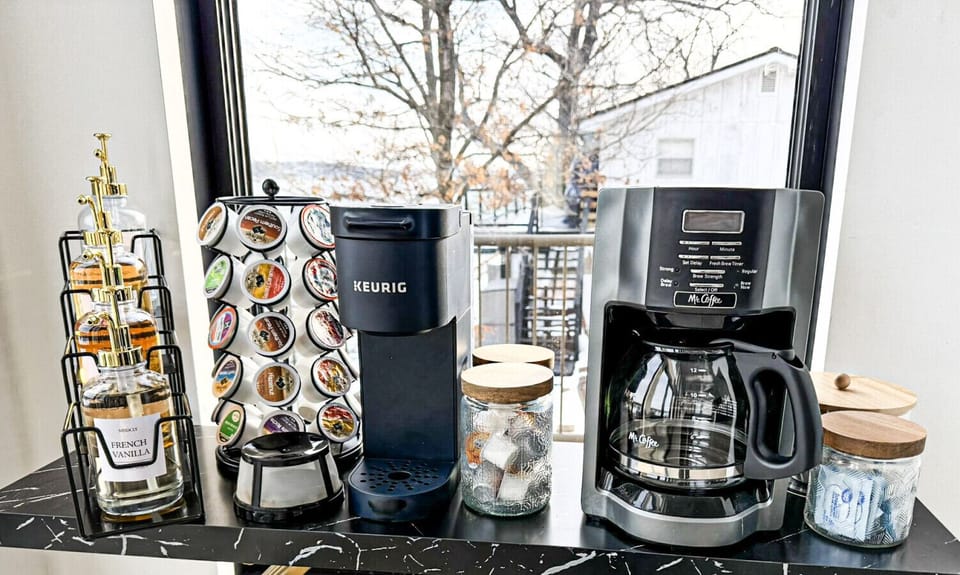 Modern coffee bar with Keurig and drip coffee maker, premium syrups, and lakeview backdrop for the perfect morning brew.
