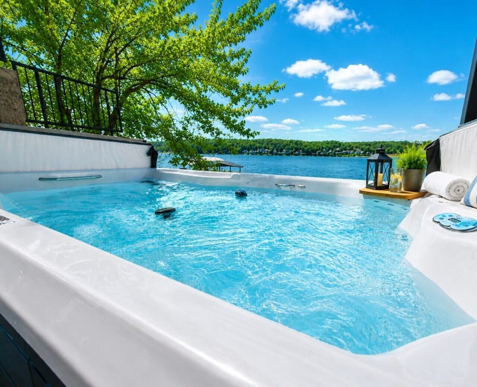 Lakeside relaxation at its finest—private spa with stunning waterfront scenery.