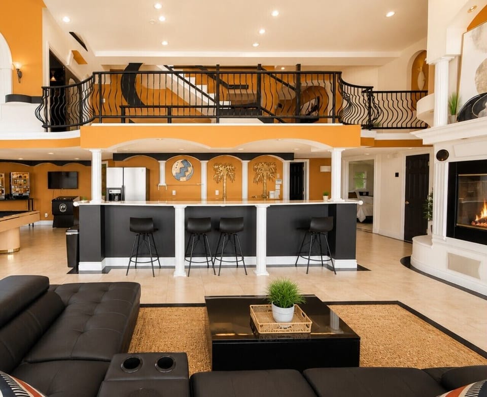 Spacious open-concept living area featuring a stylish wet bar and inviting spaces designed for entertaining.