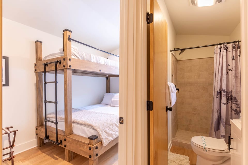 Rustic bunk beds with a full-size lower bunk keep the whole crew comfortable, right next to a convenient en-suite bath.