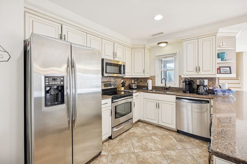 The open-concept kitchen offers plenty of prep space, making it easy to cook and enjoy meals together.