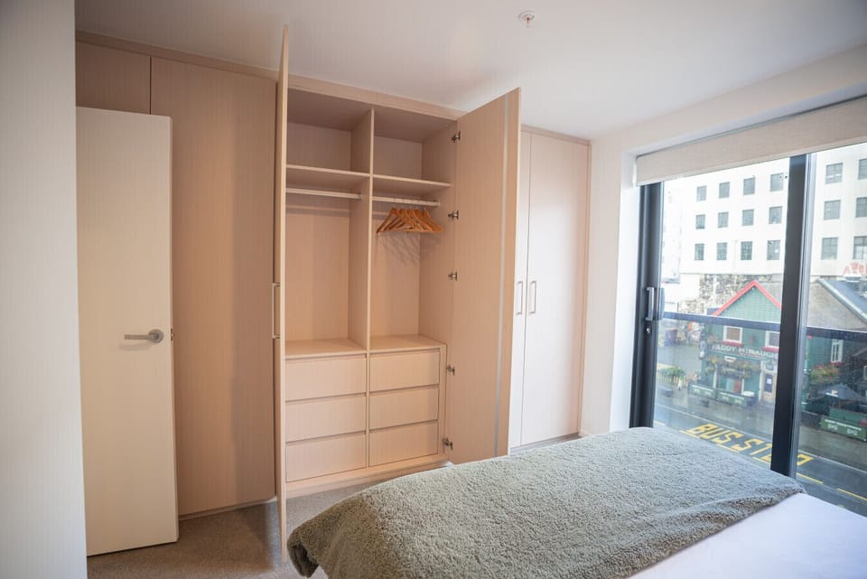 Spacious built-in wardrobe with drawers, shelving, and hanging space — perfect for short stays or longer visits. Plenty of room to unpack and feel at home.