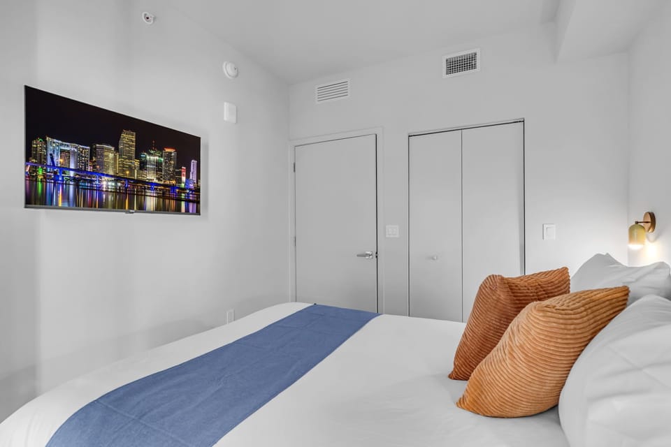 Relax and unwind in this cozy, modern bedroom. Kick back on the plush bed with vibrant blue and orange accents, and stream your favorite shows on the large flat-screen TV. Includes ample closet space to make yourself right at home