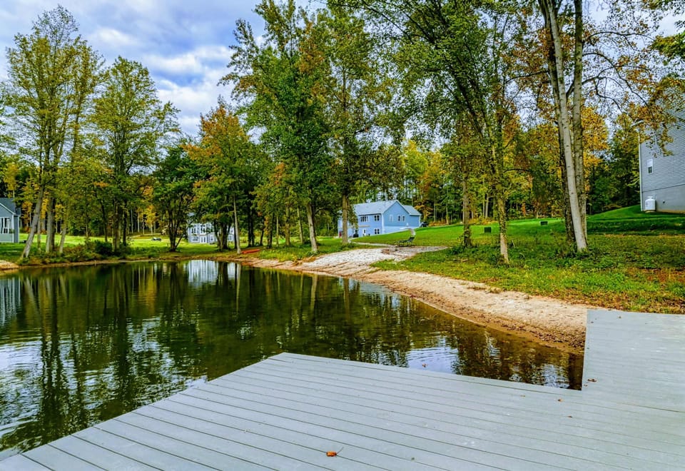 Waterfront - Sandy shoreline and winding pathway through the wooded property connect the dock to the home.