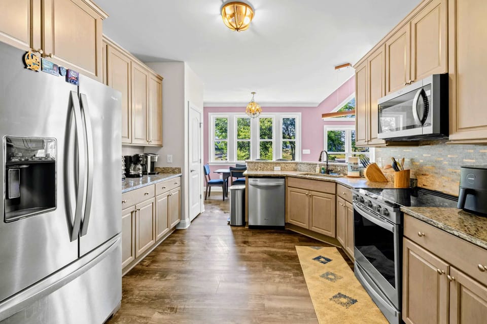 Kitchen - Galley flow with French-door refrigerator, full-size dishwasher, and prep-friendly counters on every side.