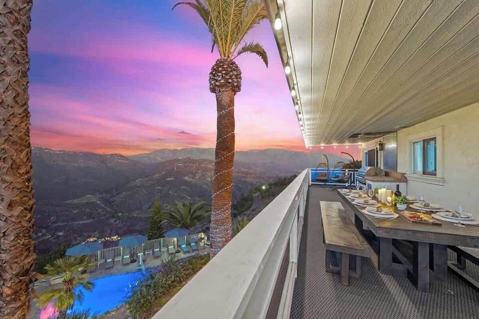 An unforgettable dining experience on a scenic balcony, where breathtaking mountain views and a glowing sunset set the perfect ambiance.