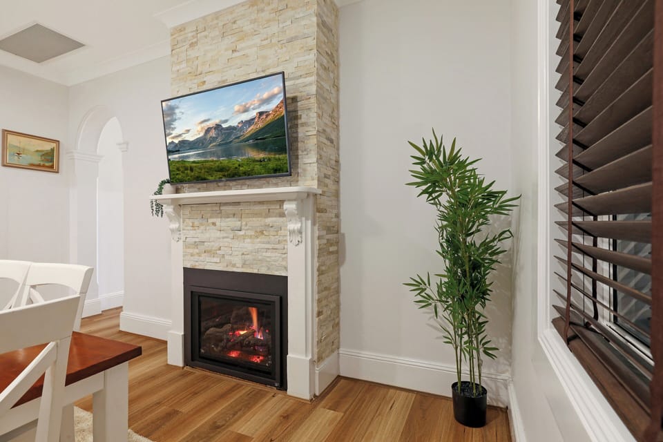 Dining area centred on the gas fireplace and wall mounted TV.