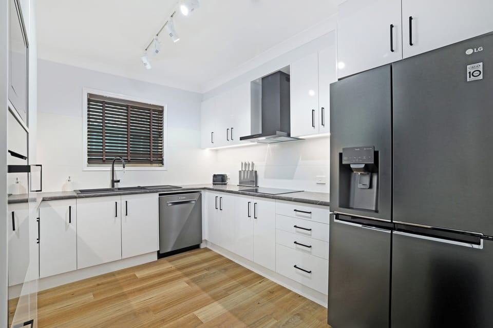 Full kitchen with generous bench space and built in appliances.