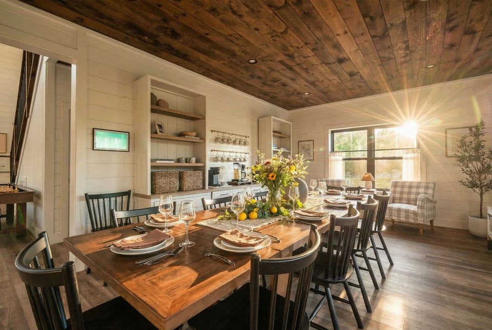 Farmhouse-style dining area with a large table, open shelving, and warm wood accents, perfect for shared meals and group gatherings.