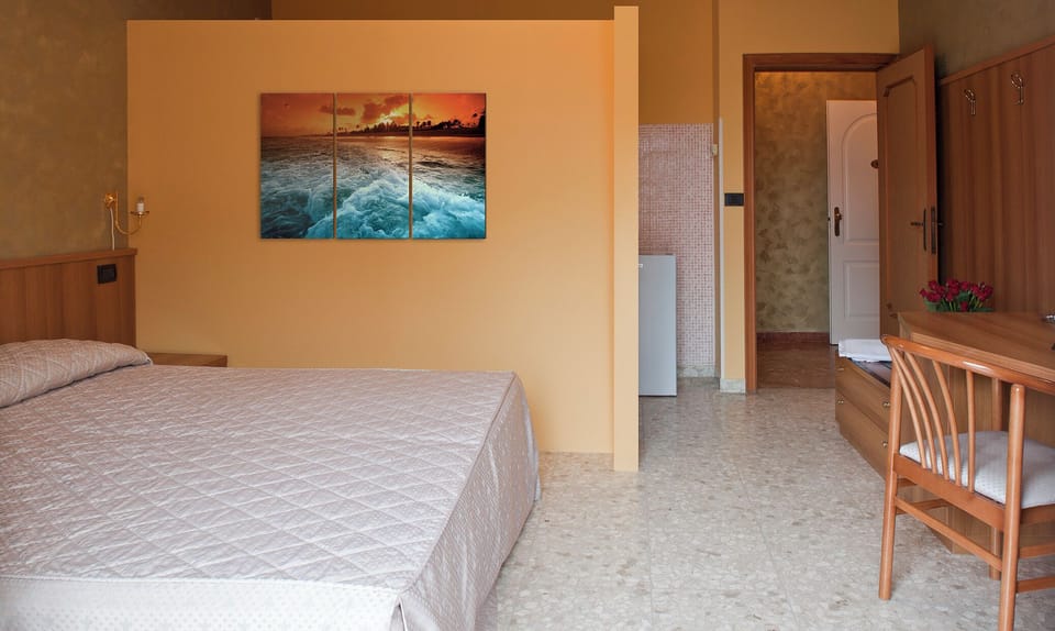 Classic Quadruple Room, Balcony, City View | In-room safe, desk, laptop workspace, iron/ironing board