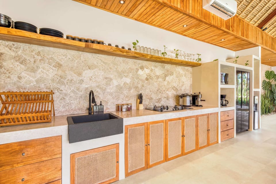 A fully equipped kitchen blending tropical charm with modern design 