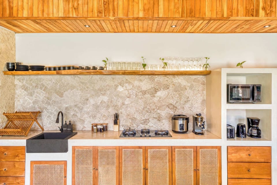 A clean, modern kitchen with tropical character that has everything you need