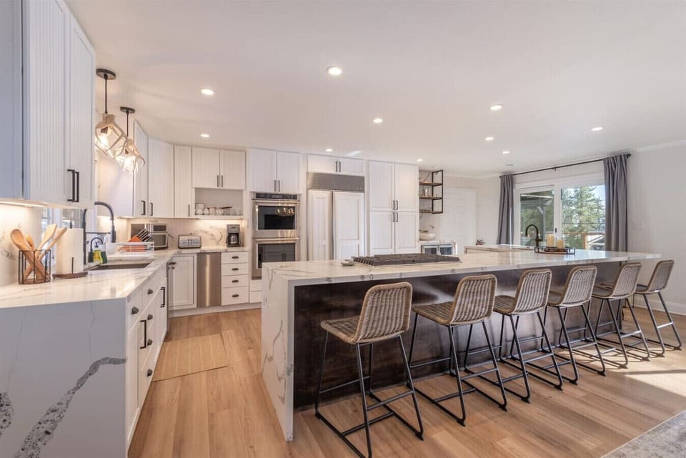 Beautifully appointed kitchen with bar seating, granite counters and high-end appliances.
