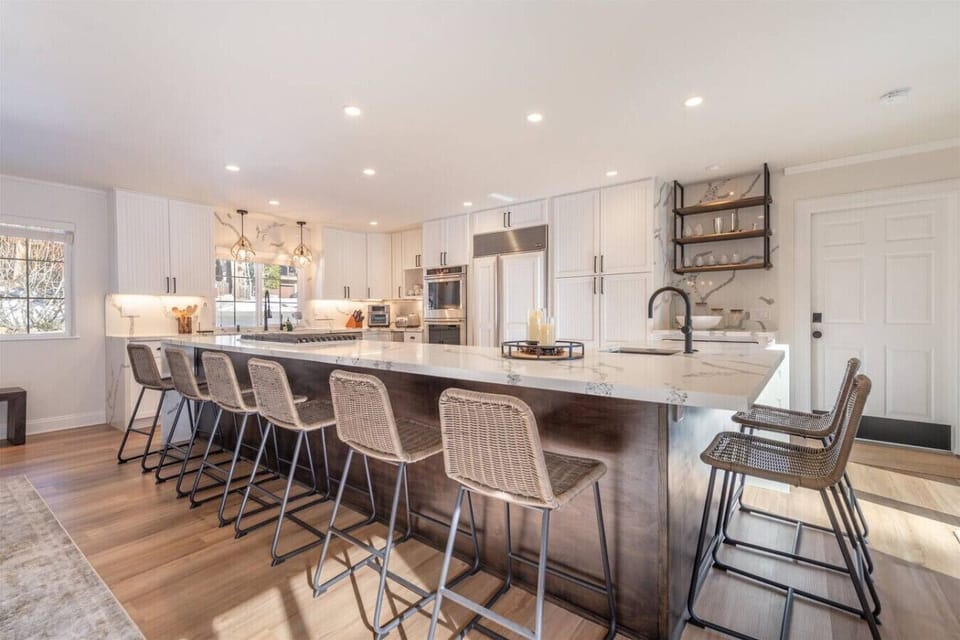 Beautifully appointed kitchen with bar seating, granite counters and high-end appliances.