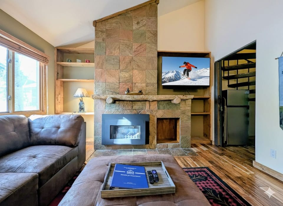 Cozy up by your stone fireplace while watching the big screen TV, perfect for relaxing après-ski evenings.