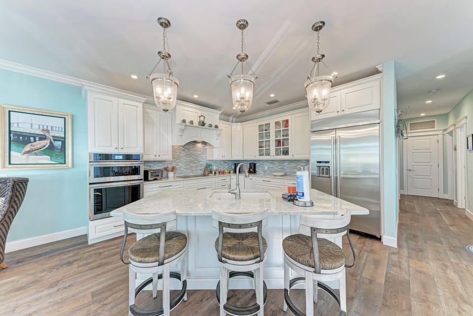 Your gourmet kitchen awaits with marble counters, stainless appliances, and elegant pendant lighting for memorable meal prep.