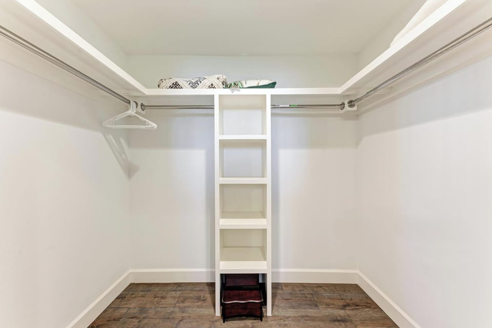 Your spacious walk-in closet offers organized storage with built-in shelving and ample hanging space for all your belongings.