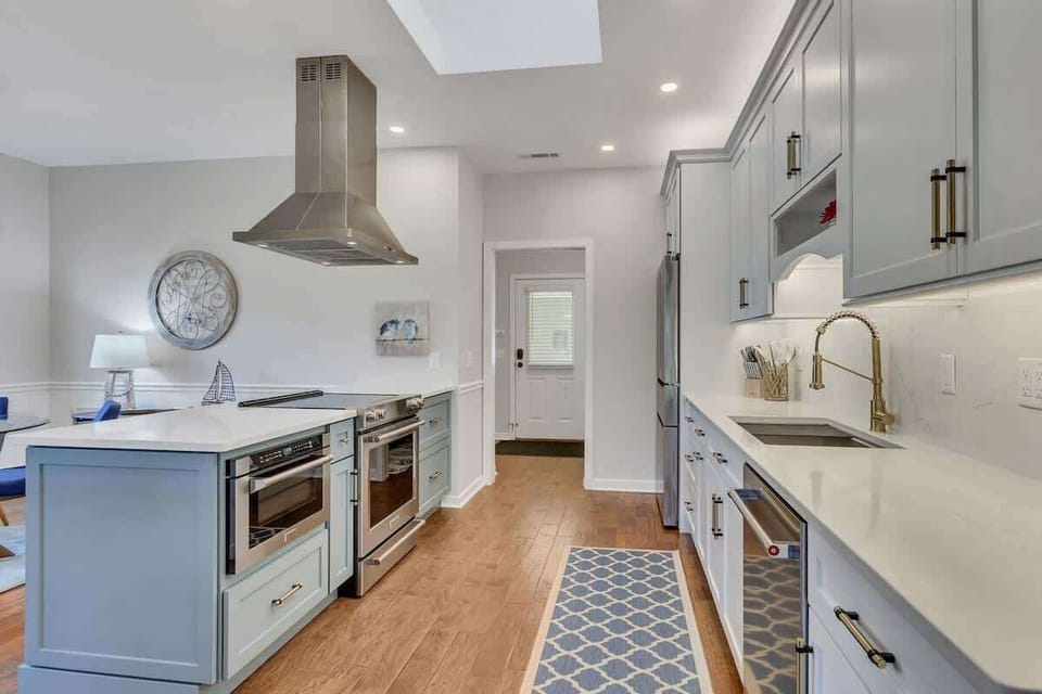 Cook like a chef in your fully equipped gourmet kitchen with gleaming countertops, modern appliances, and elegant coastal-inspired design details.