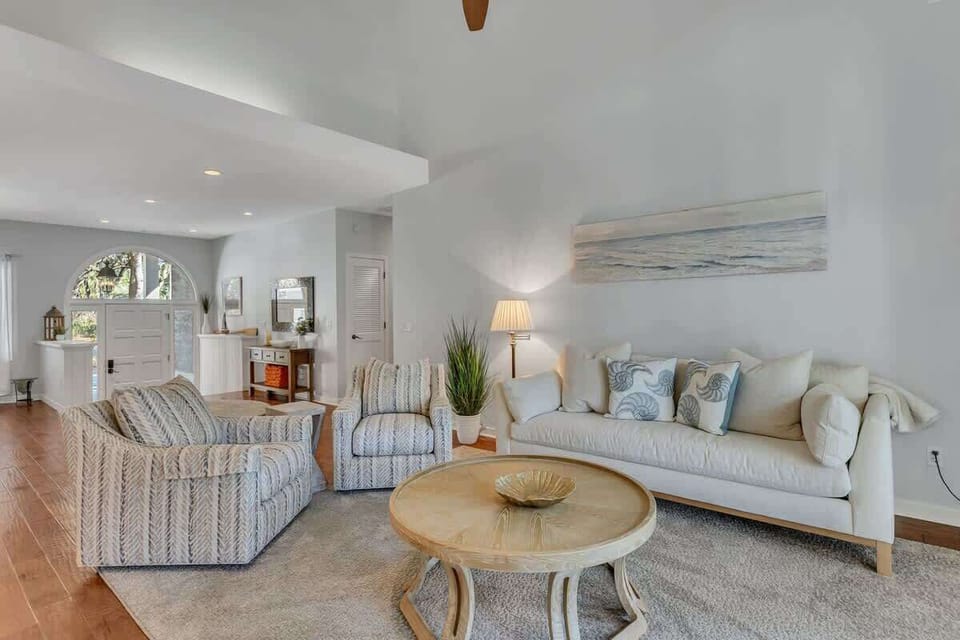 Sink into plush coastal sofas in this bright living room, where ocean-inspired decor and natural light create your perfect retreat.