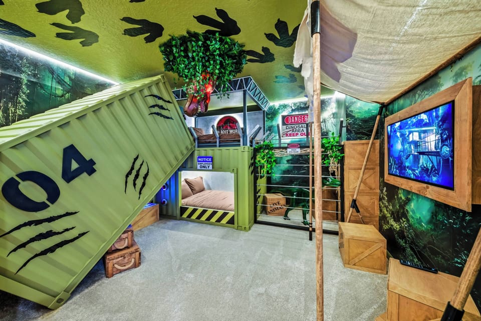 Experience a playful adventure in our uniquely themed room with a vibrant camouflage ceiling and eye-catching shipping container design, where textured walls and wooden accents create an immersive atmosphere to spark your.