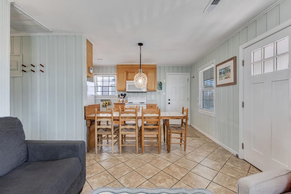Gather around your welcoming dining table where coastal charm meets comfort in this open-concept space.