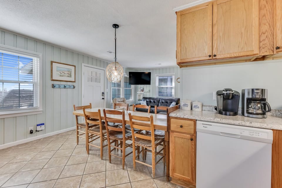 Gather around your breakfast bar for morning coffee before exploring, with warm wood finishes and coastal charm throughout your kitchen.