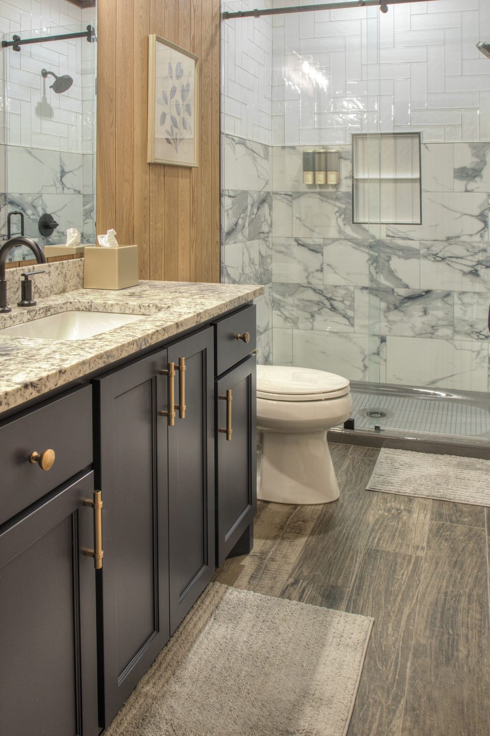Master bathroom with tiled shower and glass sliding door.