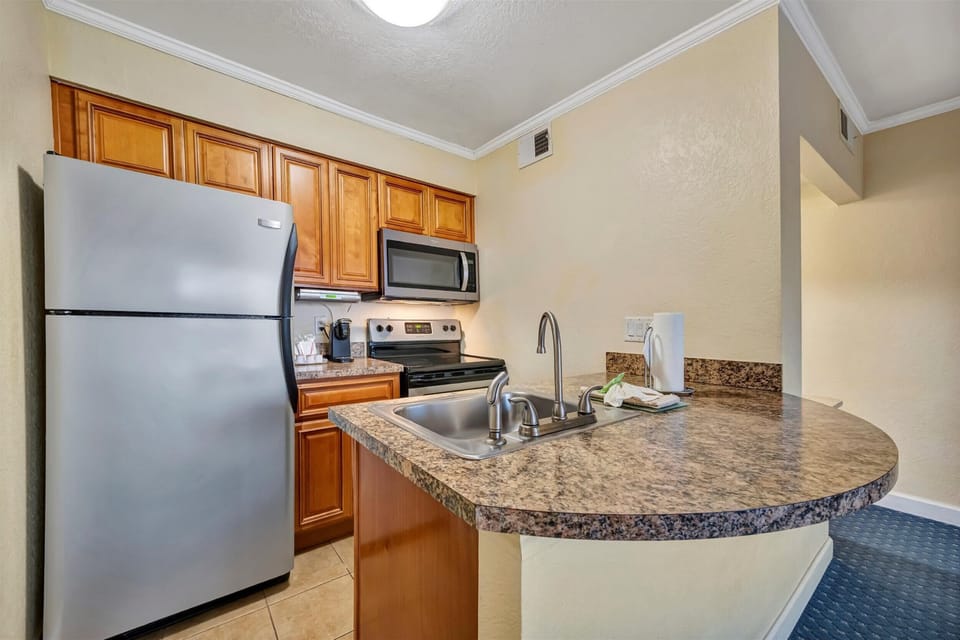 Compact kitchen with fridge and prep space