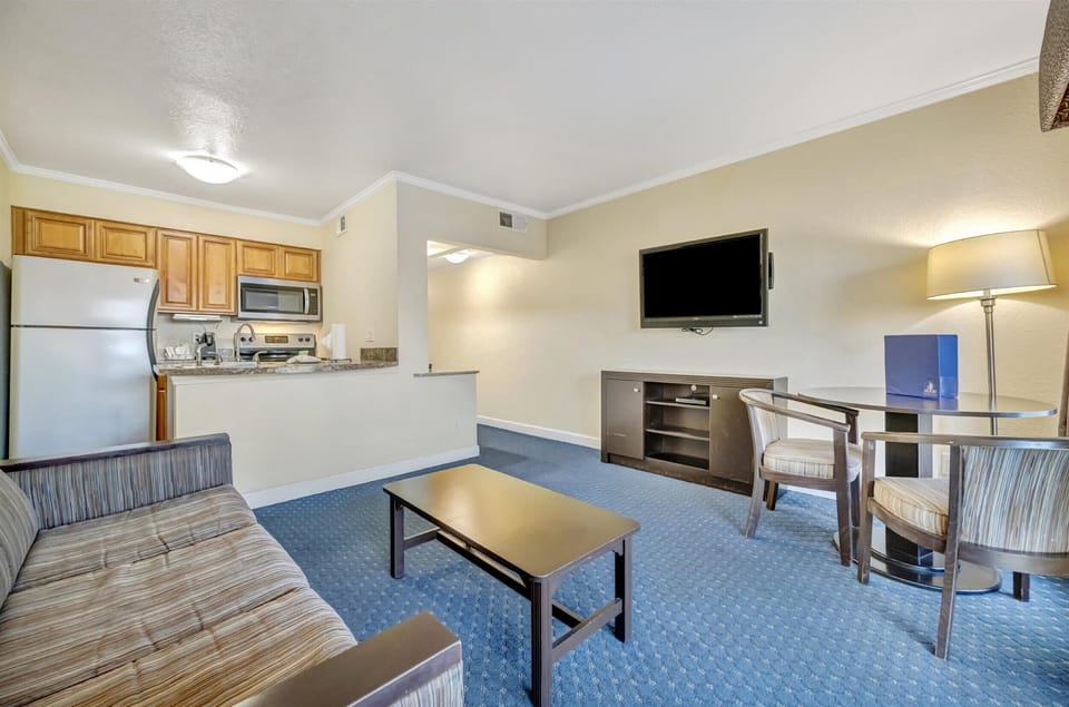 Open living area with kitchen and dining nearby