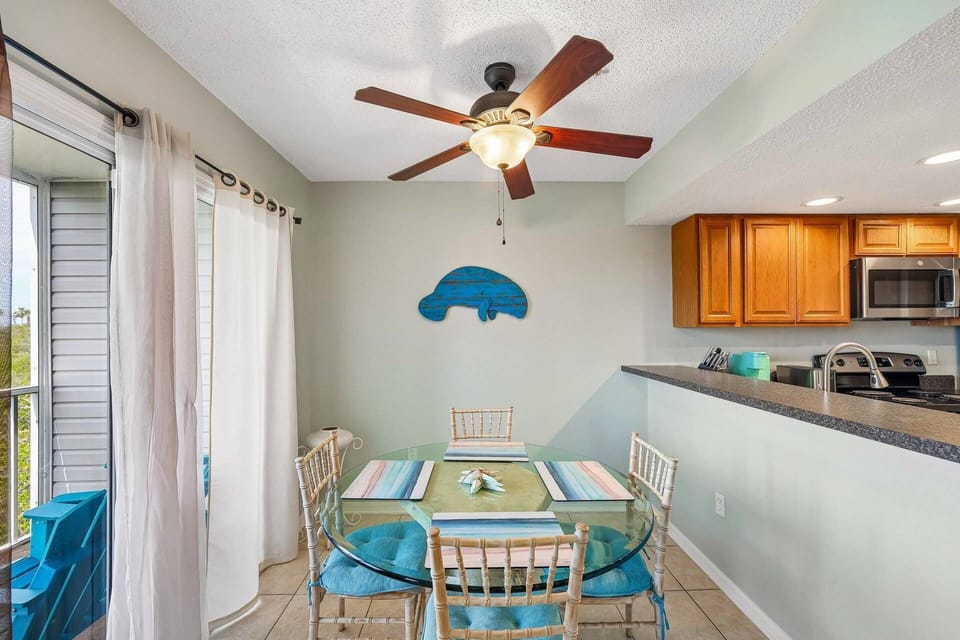 Coastal-inspired dining area beside the screened balcony