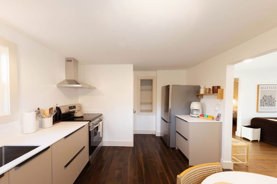 Fully equipped modern kitchen featuring an induction cooktop, stainless steel appliances, microwave, and a stylish SMEG coffee maker to start your day right.