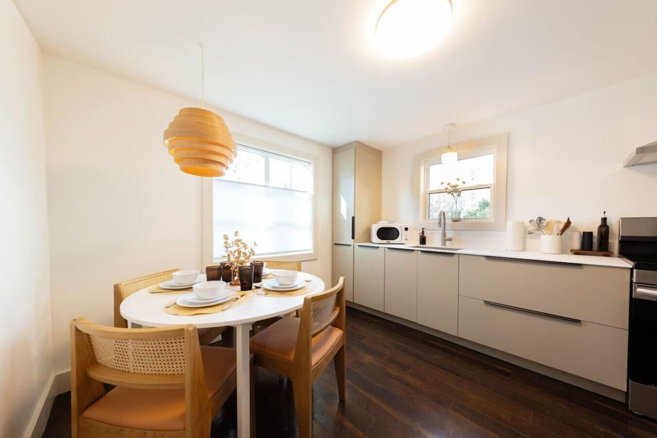 Dining area for four, finished with warm hardwood floors and mid-century modern touches.