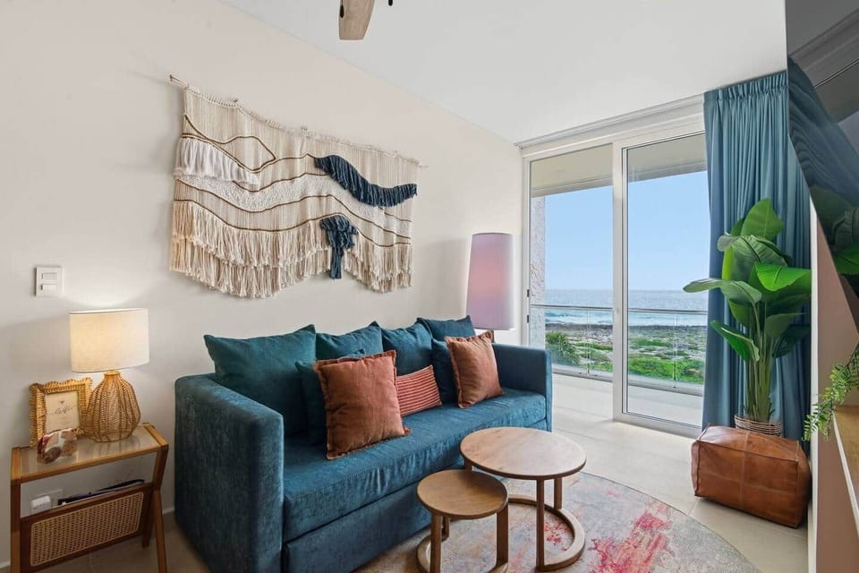 This inviting living room offers a sofa bed for two, a Smart TV with access to your favorite streaming services including Netflix, air conditioning, ceiling fan, and direct access to a private balcony to enjoy beautiful ocean views.