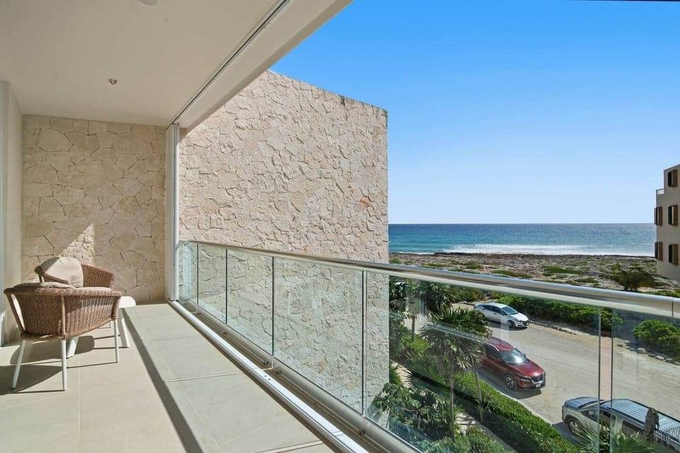 Private balcony with beautiful ocean views and outdoor seating, ideal for unwinding while taking in the fresh ocean breeze.