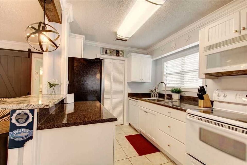 Kitchen area with granite countertops.