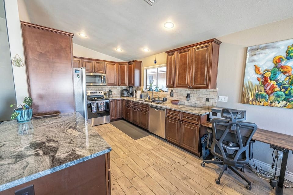 Fully stocked kitchen with plenty of space to cook, gather, and work — featuring a dedicated workspace and printer.
