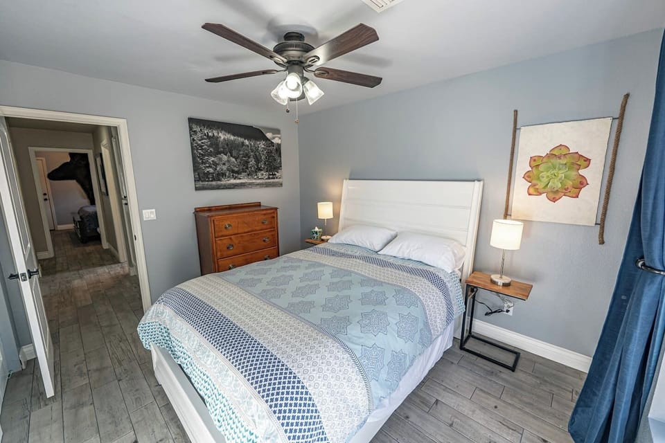 Another view of the guest bedroom showing dresser storage and a comfortable layout.