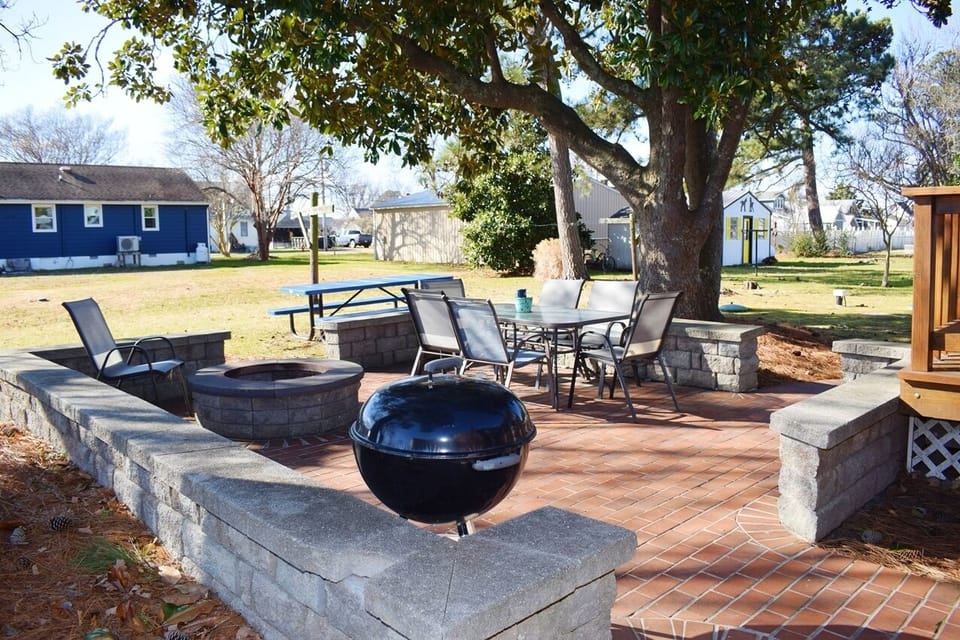 Enjoy the backyard patio with firepit, grill, and outdoor dining.