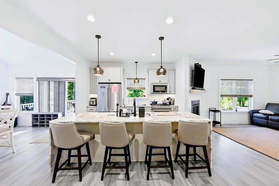 Kitchen - Full-size stainless refrigerator and ample prep space, stocked for cooking on vacation.