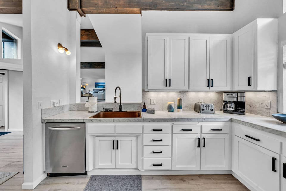 Kitchen: Open space with white countertops and new appliances