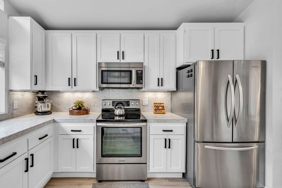 Kitchen: Open space with white countertops and new appliances