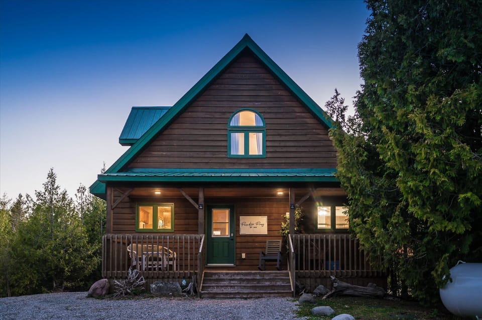 Welcome to Paradise Pines, a custom-built waterfront getaway with warm wood finishes and a bright open-concept design.