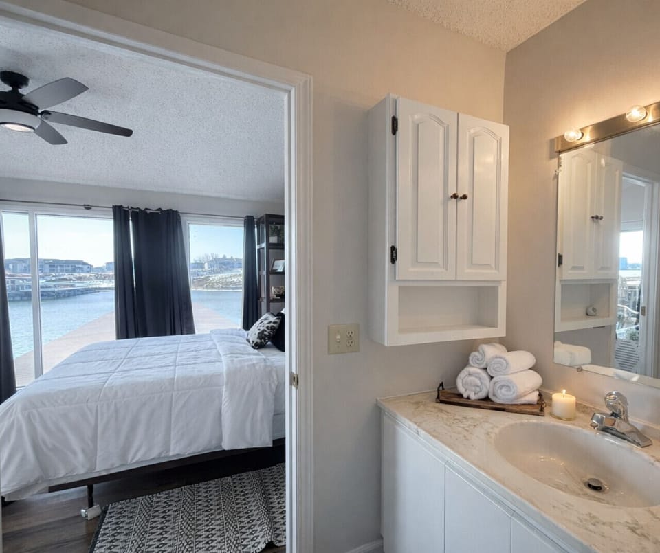 Unwind in this spacious master bedroom with a private bath and beautiful lake views.