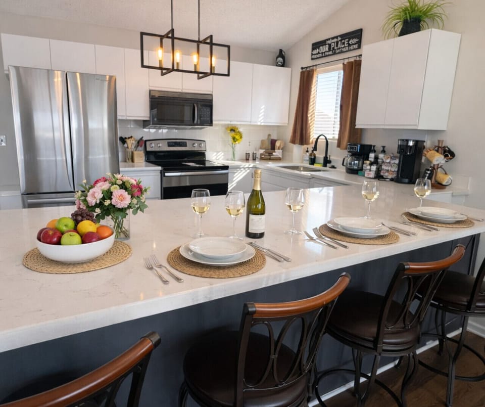 Bright modern kitchen with stainless steel appliances, spacious island seating, and elegant lake house design.